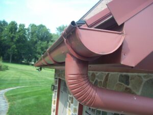 close up of red gutter and downspout